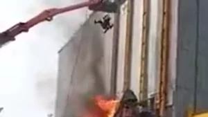 Hot Work Fire - Over Plastic Tarps With Workers In Lift Over Fire