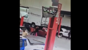 Truck gets pulled off lift by and onto mechanic